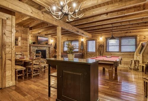 a dining room with a pool table in a log cabin at Bridgewood Cabin, Hot Tub, FREE Attraction tickets, WIFI!!! in Pigeon Forge