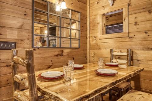 a dining room with a wooden table and chairs at Bridgewood Cabin, Hot Tub, FREE Attraction tickets, WIFI!!! in Pigeon Forge