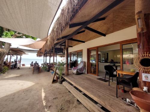 a restaurant on the beach with chairs and tables at Avila's Horizon Dive Resort Malapascua in Malapascua Island