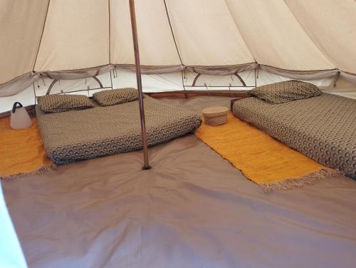 a tent with two beds in a room at La Pause Mafate in La Possession