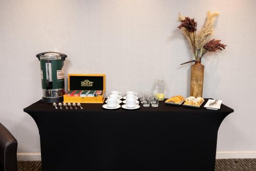 a black table with food and a vase on it at Holiday Inn Express - Iquique by IHG in Iquique