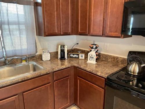 a kitchen with a sink and a counter top at Family friendly home WiFi modern comfort in Greenville