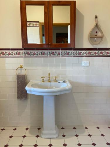 a bathroom with a sink and a mirror at Nirvana Farm House in Woolamai