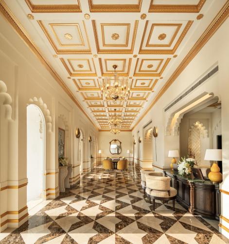 a lobby with a coffered ceiling and black and white tiles at Taj Usha Kiran Palace, Gwalior in Gwalior
