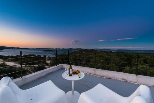 a view of the ocean from a house with a table and chairs at Villa Gordan - Happy Rentals in Dragove