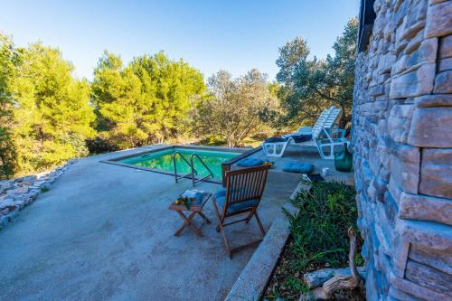 a yard with a chair and a swimming pool at Villa Gordan - Happy Rentals in Dragove