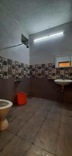 a bathroom with a toilet and a sink at Le Grace Beachview in Chennai