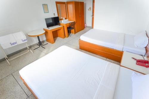Ένα ή περισσότερα κρεβάτια σε δωμάτιο στο Tokyo Hotel