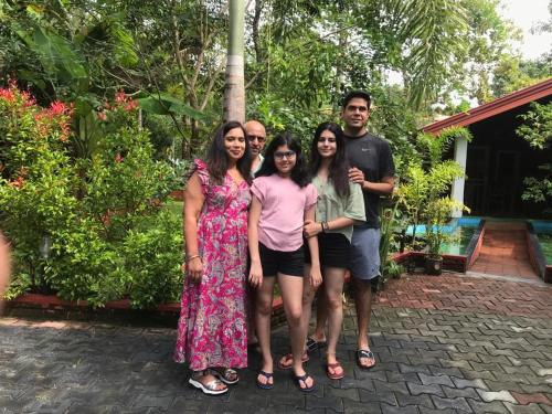a group of people posing for a picture in front of a house at Sigiriya Cashew Palace Resort in Sigiriya