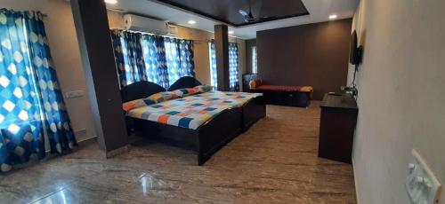 a bedroom with a bed and a couch in a room at Le Grace Beachview in Chennai