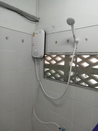 a bathroom with a blow dryer attached to a wall at Tiki Tribe Bar & Hostel in Koh Tao