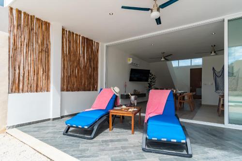 a patio with two chairs and a table at Casa Arena mia, Chicxulub by Casago in Chicxulub