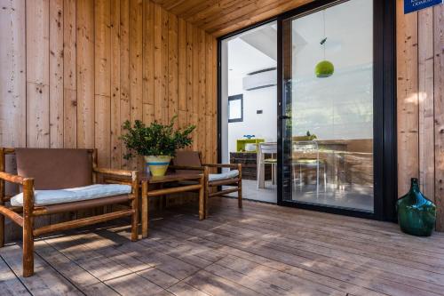 a patio with two chairs and a table and a table at Villa Sun House - Happy Rentals in Dragove