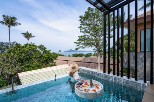 a teddy bear sitting in a pool in a house at Aonang Princeville Villa Resort & Spa - GHA WellHotel-Halal Certified, Krabi, Thailand in Ao Nang Beach