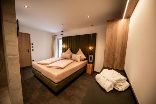 a bedroom with a large bed and a window at Studio Weitblick in Saalbach-Hinterglemm