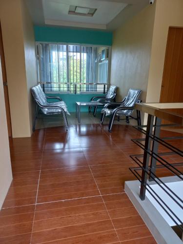 a waiting room with four chairs and a table at CELCOR PENSION HOUSE in Cabatuan