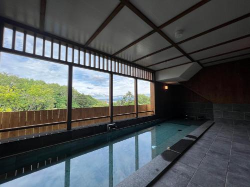 a swimming pool with a view of the mountains at Takasago Onsen in Asahikawa