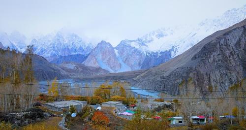 a view of a snowy mountain range with a lake at Apex Hotels and Resorts Hussaini in Hunza