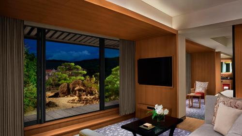 a living room with a large window with a view at The Ritz-Carlton Kyoto in Kyoto