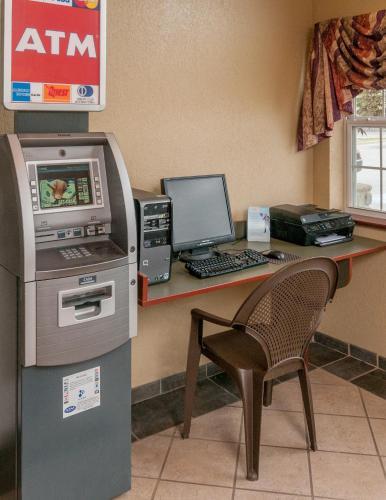 an office with a desk with a cash register and a computer at Microtel Inn & Suites Beckley East in Beckley