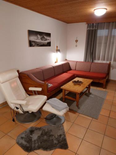 a living room with a couch and a table at Apartment Gerlitzen Garden in Treffen