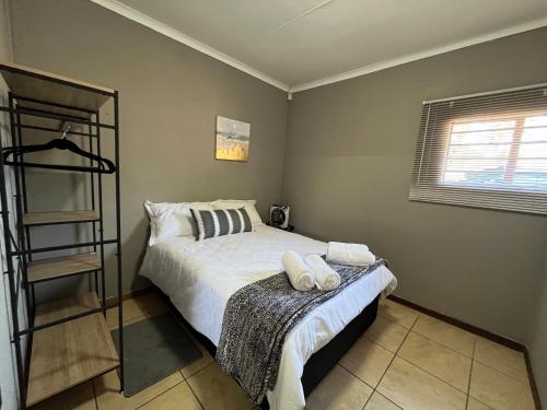 a bedroom with a bed with two towels on it at 1 on Titania in Polokwane