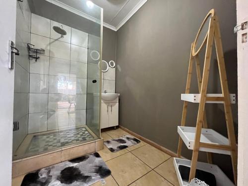 a bathroom with a shower and a glass shower stall at 1 on Titania in Polokwane