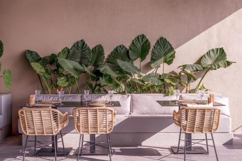 a table with two chairs and a couch with plants at Balmy Beach Resort Kemer in Kemer