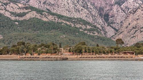 a large body of water with mountains in the background at Balmy Beach Resort Kemer in Kemer