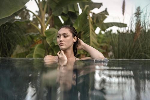 a woman in the water in a swimming pool at Balmy Beach Resort Kemer in Kemer