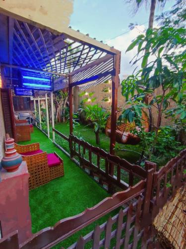 a patio with green grass and a fence at LARA Maamoura beach Alexandria in Alexandria