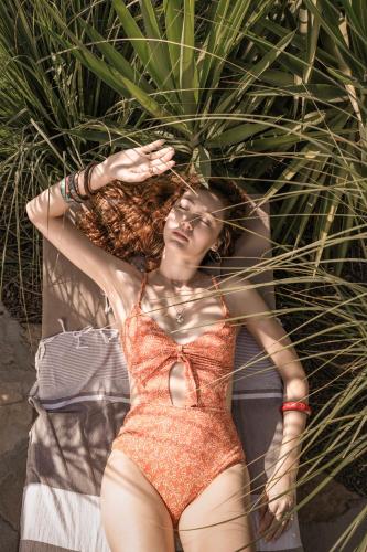 a woman laying on a towel on the beach at Balmy Beach Resort Kemer in Kemer