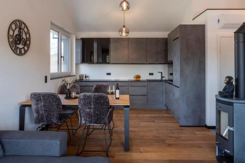 a kitchen and dining room with a table and chairs at RiverVista Apartments by mi_vida in Bad Waltersdorf