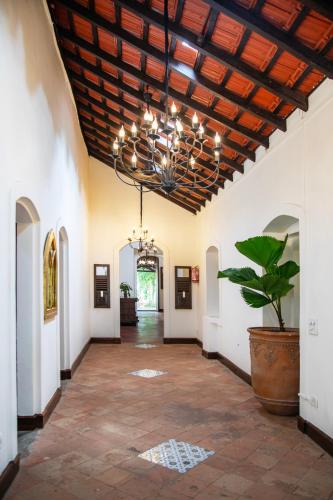 a large hallway with a ceiling with a chandelier at Lamrin Ucassaim Goa An Indo Portuguese Hotel in Moira