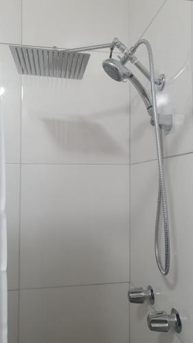 a shower with a shower head in a bathroom at Kozy Bahamas Getaway in Nassau