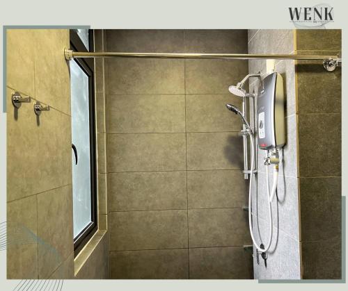 a shower stall in a bathroom with a window at Neu Suites 006 A in Kuala Lumpur
