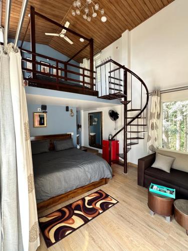 a bedroom with a bed and a spiral staircase at Sharma Nivas Holiday Homestay in Yelagiri