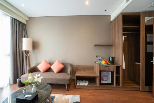 a living room with a couch and a table at Northern Charm Hotel in Ho Chi Minh City