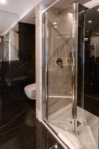 a glass shower in a bathroom with a toilet at Hotel Bellavista in Marina di Varcaturo