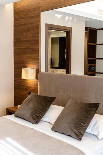 a bedroom with a bed with two pillows at Hotel Bellavista in Marina di Varcaturo