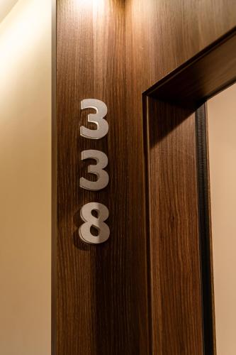 a wooden door with theacco sign on it at Hotel Bellavista in Marina di Varcaturo