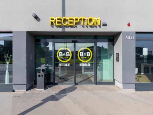 a store front with two signs on the doors at B&B Hotel Neuss in Neuss