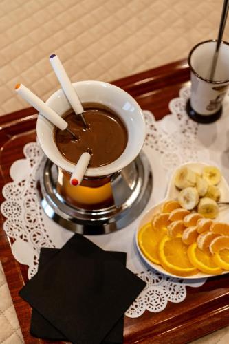 a table with a cup of coffee and a plate of fruit at Hotel Bellavista in Marina di Varcaturo