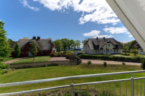 a view of two houses and a yard at Strandvilla "Babette" - BALO B, direkt am Meer, mit Sauna in Lobbe