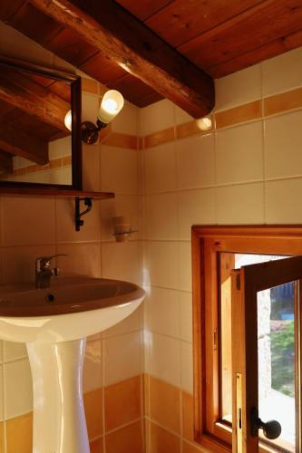 a bathroom with a sink and a mirror at Diminio 1 Whole House - Chalet in Arachova