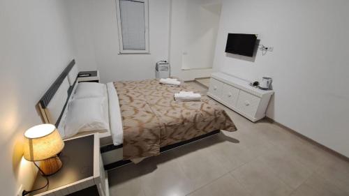 a bedroom with a bed and a television in it at Kai Hotel in Tbilisi City