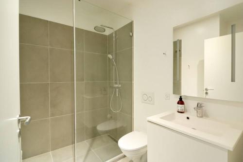 a bathroom with a shower and a toilet and a sink at Nordic style top location balcon in Copenhagen