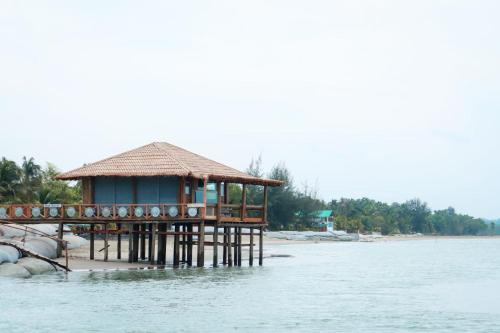 a house on a pier in the water at Mermaid Beach Resort in Dhoāpālong