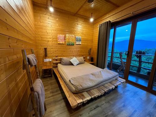 a bedroom with a bed in a wooden room at Tà Đùng May Farm in Biđong