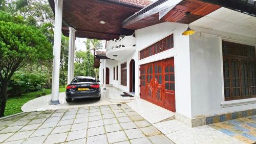 a car parked in front of a house at Anuradhapura Villa by TEMCO Holiday Bungalows in Anuradhapura